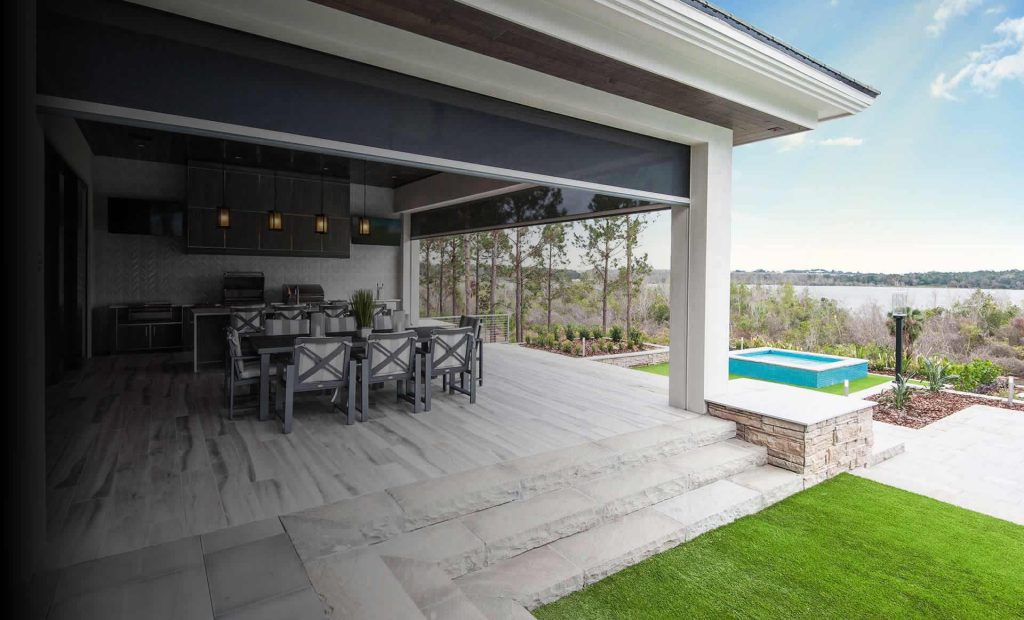Motorized patio screen lowered across a covered porch opening on a Charleston area home